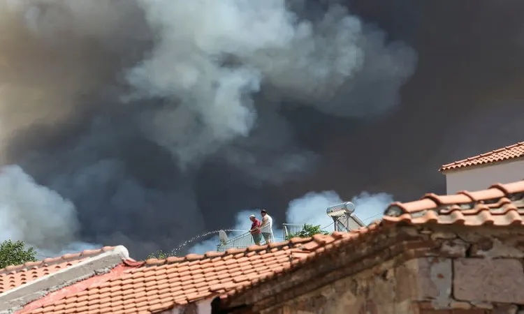 Wildfires burn coastal homes, forests in Greece as heatwave spreads east