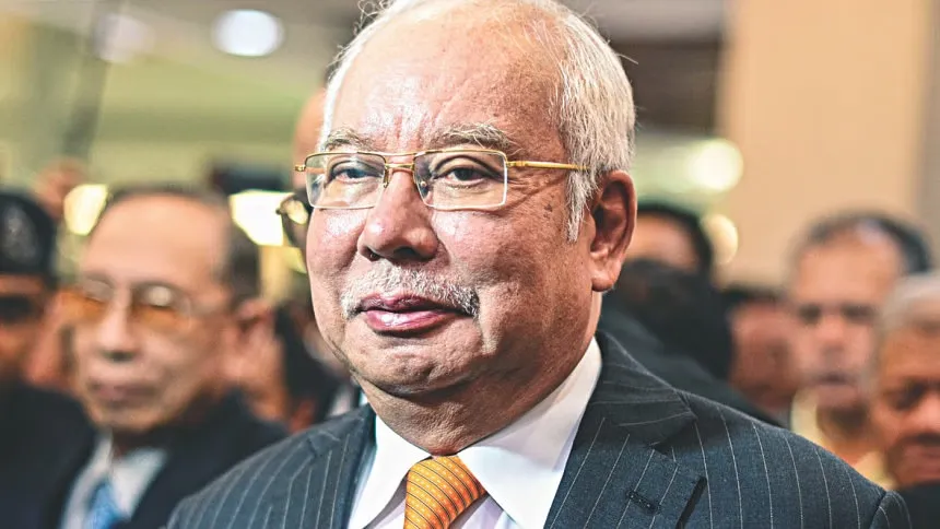 Malaysia halves jail sentence of ex-PM Najib