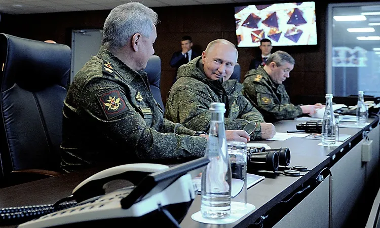 Putin watches military drills with China